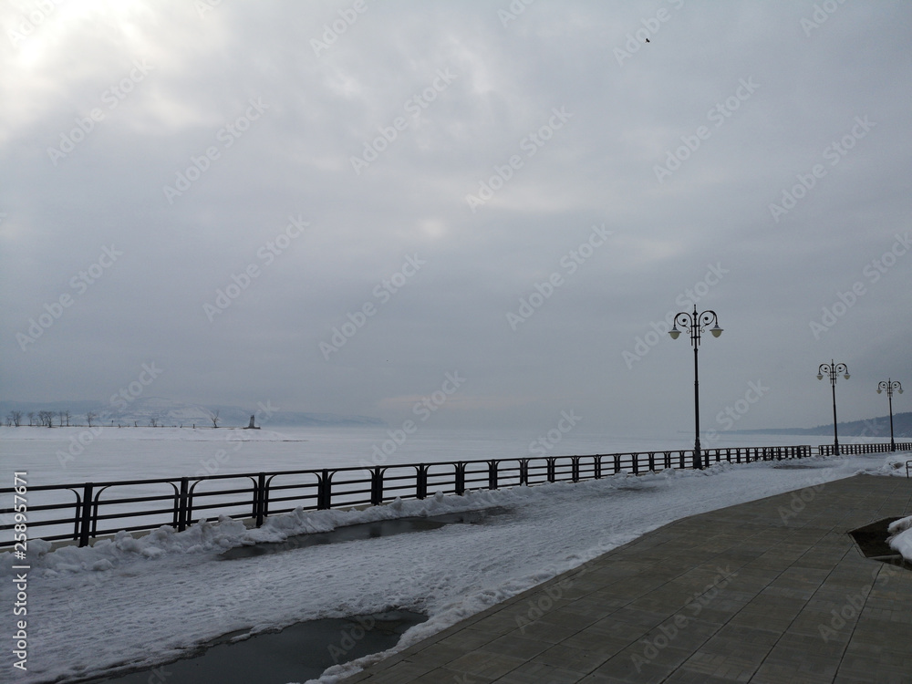 Embankment in the snowy Russian landscape in early spring