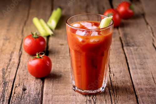 Fresh Tasty Tomato Celery Juice in Glass Fresh Tomatoes and Green Celery on Old Wooden Background Healthy Detox Drink Horizontal