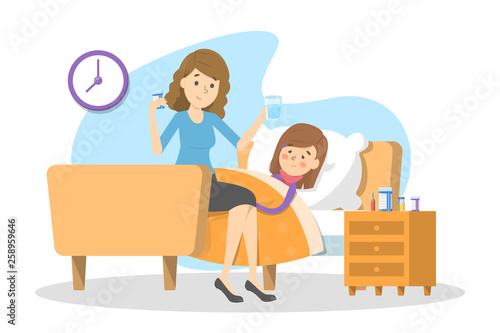 Mother gives pills to a sick child with fever