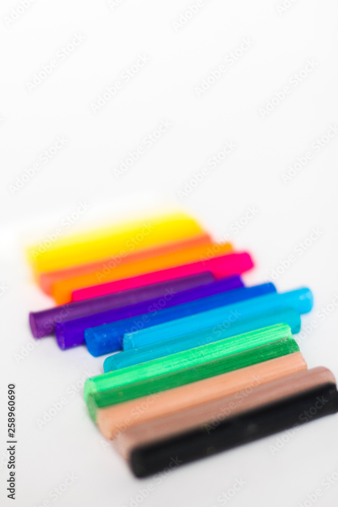 multi colored chalk pastels on a white background multi colored chalk pastels on a white background