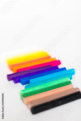 multi colored chalk pastels on a white background