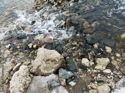 Fresh water stream in mountain brook, closeup. The texture of the rocky surface in the water © Vladimir