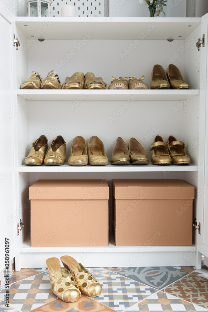 Old fashionable women shoes painted with gold paint. Capsule wardrobe, order in the closet, shoes compiled neatly. Concept. Cleaning. Wardrobe order. Cloak study. Footwear.