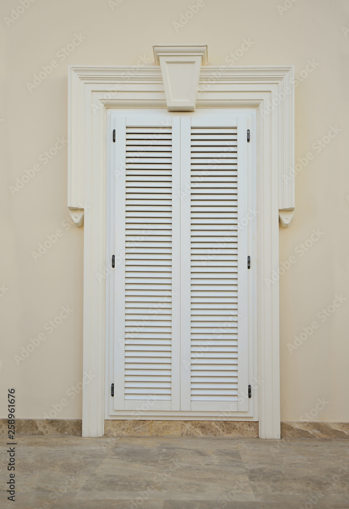 Front door, front view of a white door with white exterior Front door, front view of a white door with white exterior