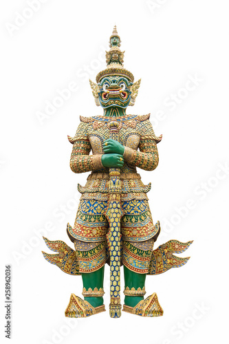 Green giant guardian statue which has long white fangs wearing a crown and traditional thai dresses in thai literature standing and carrying weapons isolated on white background.