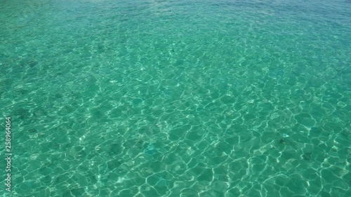 Bright Blue seawater ripples and relfects light off of it's surface in a tropical paradise. photo