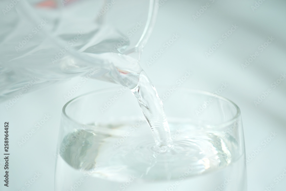 Clean water for good health. Pouring Fresh Pure Water From Pitcher Into A Glass on table wooden. Health And Diet Concept. Lifestyle Healthcare And Beauty. Clean water for good health. Pouring Fresh Pure Water From Pitcher Into A Glass on table wooden. Health And Diet Concept. Lifestyle Healthcare And Beauty.