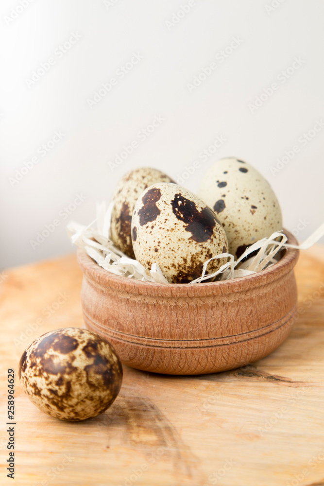 Obraz premium quail eggs in a nest on a white background