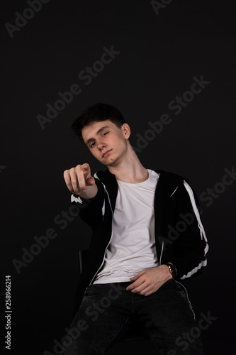 handsome young man posing on black background