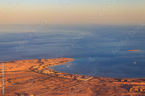 Aerial view on Red sea  Arabian desert and touristic resort near Hurghada  Egypt. View from airplane