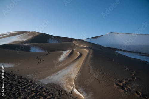 Dunhuang ,  China :  The Silk road - Mingsha sand mountain (Gobi desert) with snow covered in the early winter