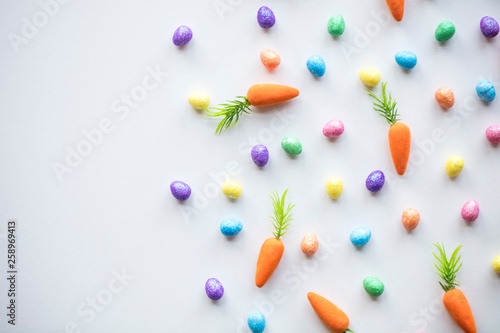 Easter seasonal background with colourful eggs and carrots