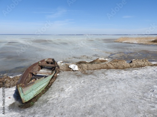 Boat in winter on the shores of lake Pleshcheyevo, Pereslavl Zalessky, Yaroslavl region, Russia on a clear day.