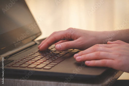 Woman's hands is typing on laptop keyboard. Online working. Worker and business concept