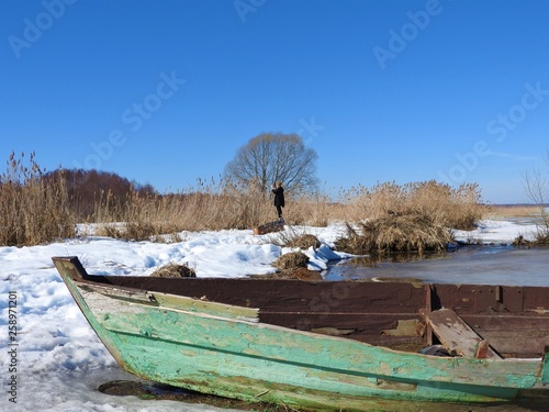 Boat in winter on the shores of lake Pleshcheyevo, Pereslavl Zalessky, Yaroslavl region, Russia on a clear day. photo