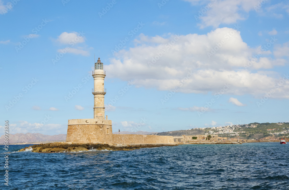  Lighthouse. Beautiful view to the rocky coast with ancient architecture. Seaport touristic town Chania, Creete island, Greece. Turquoise sea with waves.