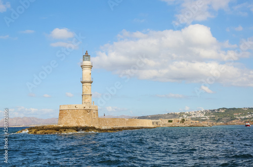  Lighthouse. Beautiful view to the rocky coast with ancient architecture. Seaport touristic town Chania, Creete island, Greece. Turquoise sea with waves.