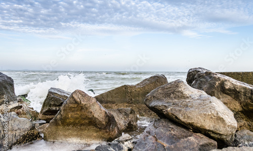 seascape with rocks and surf in the foreground