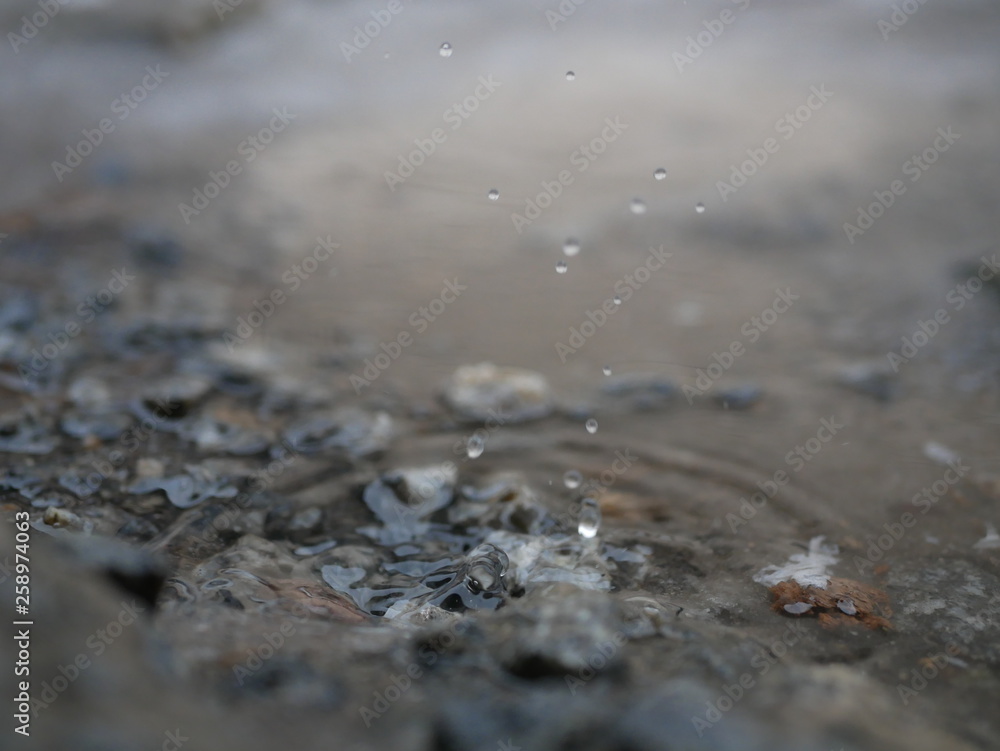 Polonne / Ukraine - 31 January 2019: Close up on water drop with water wave Polonne / Ukraine - 31 January 2019: Close up on water drop with water wave