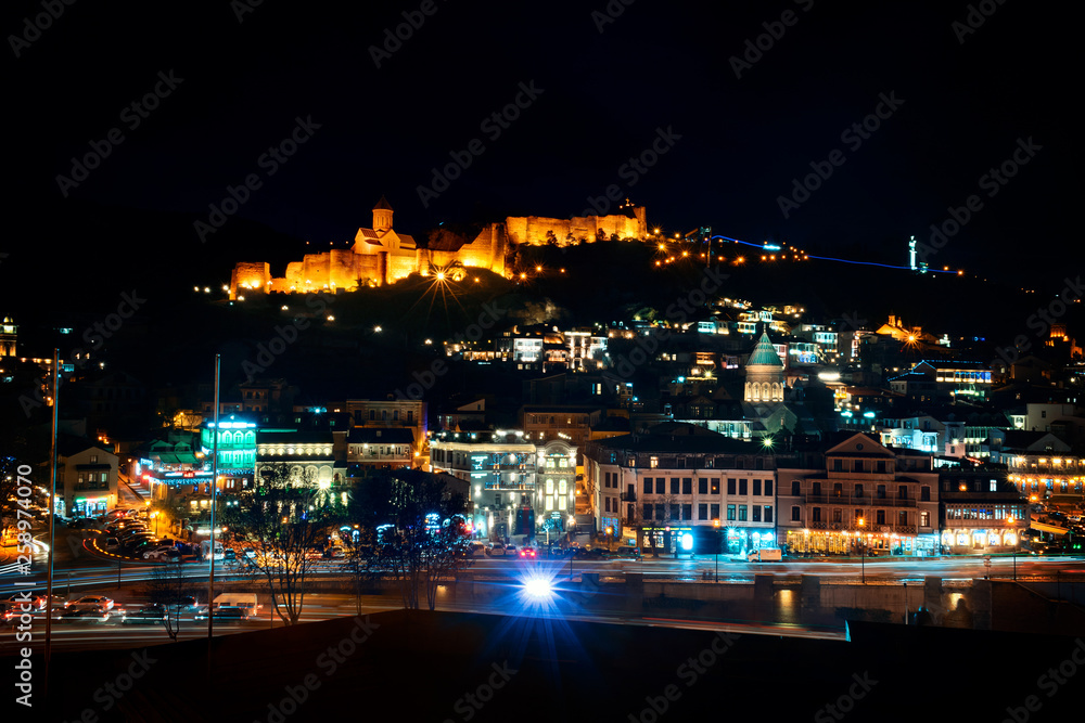Georgia, Tbilisi - 05.02.2019. - View over Narikala fortress and Tbilisi old town architecture illuminated in the night time.