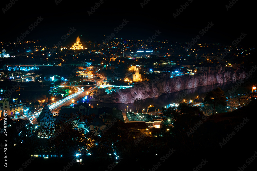 Georgia, Tbilisi - 05.02.2019. - Areal view over Tbilisi old town and Avlabari district across the river Mtkvari. Holly trinity church illuminated with golden light - Image Georgia, Tbilisi - 05.02.2019. - Areal view over Tbilisi old town and Avlabari district across the river Mtkvari. Holly trinity church illuminated with golden light - Image