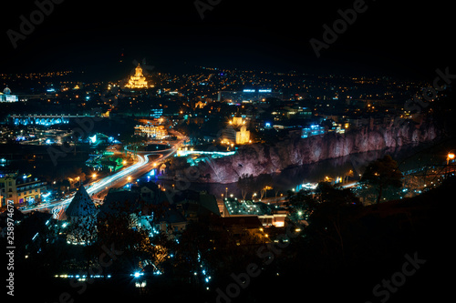 Georgia, Tbilisi - 05.02.2019. - Areal view over Tbilisi old town and Avlabari district across the river Mtkvari. Holly trinity church illuminated with golden light - Image © predragmilos
