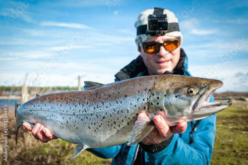 Happy angler with big sea trout