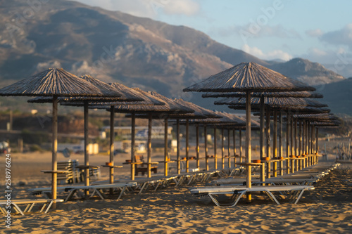 Bamboo, reed, straw beach umbrellas on the beach Falasarne, Greece, Crete photo