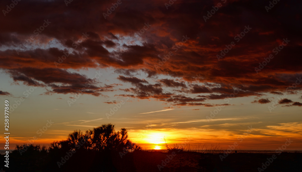 Coast of the Atlantic Ocean. Sundown. The bright colors of the sky and clouds that are colored by the rays of sunset. Coast of the Atlantic Ocean. Sundown. The bright colors of the sky and clouds that are colored by the rays of sunset.