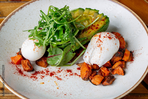 Sweet potato cubes rocket salad wit avocado and pouched eggs, homemade and healthy 