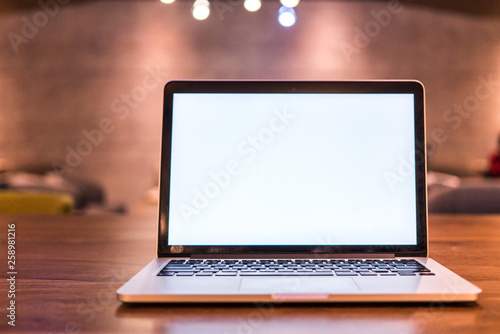 Conceptual workspace, Laptop computer with blank white screen on table, blurred background. use in Traditional Chinese Alphabet operating system.