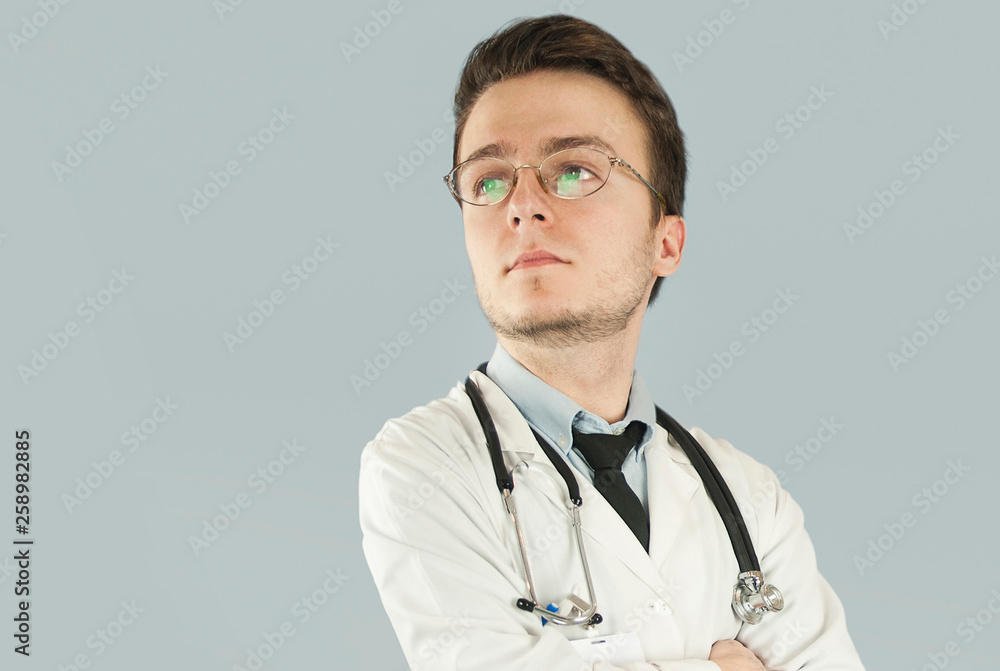 Doctor senior man, medical professional holding something in empty hand isolated over blue background Doctor senior man, medical professional holding something in empty hand isolated over blue background