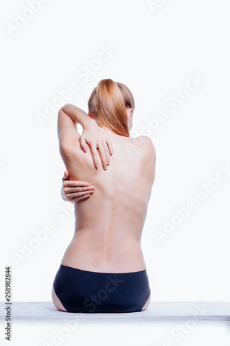 Back of beautiful nude woman on white background
