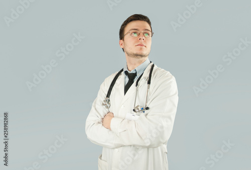 Doctor senior man, medical professional holding something in empty hand isolated over blue background ©  Даниил Дудник
