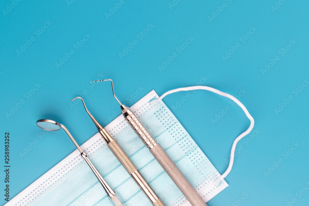 Professional Dentist tools in dental office: dentist mirror, dental probe, sickle probe. Dental Hygiene and Health conceptual image. - Image