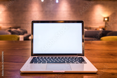 Conceptual workspace, Laptop computer with blank white screen on table, blurred background. use in Traditional Chinese Alphabet operating system.
