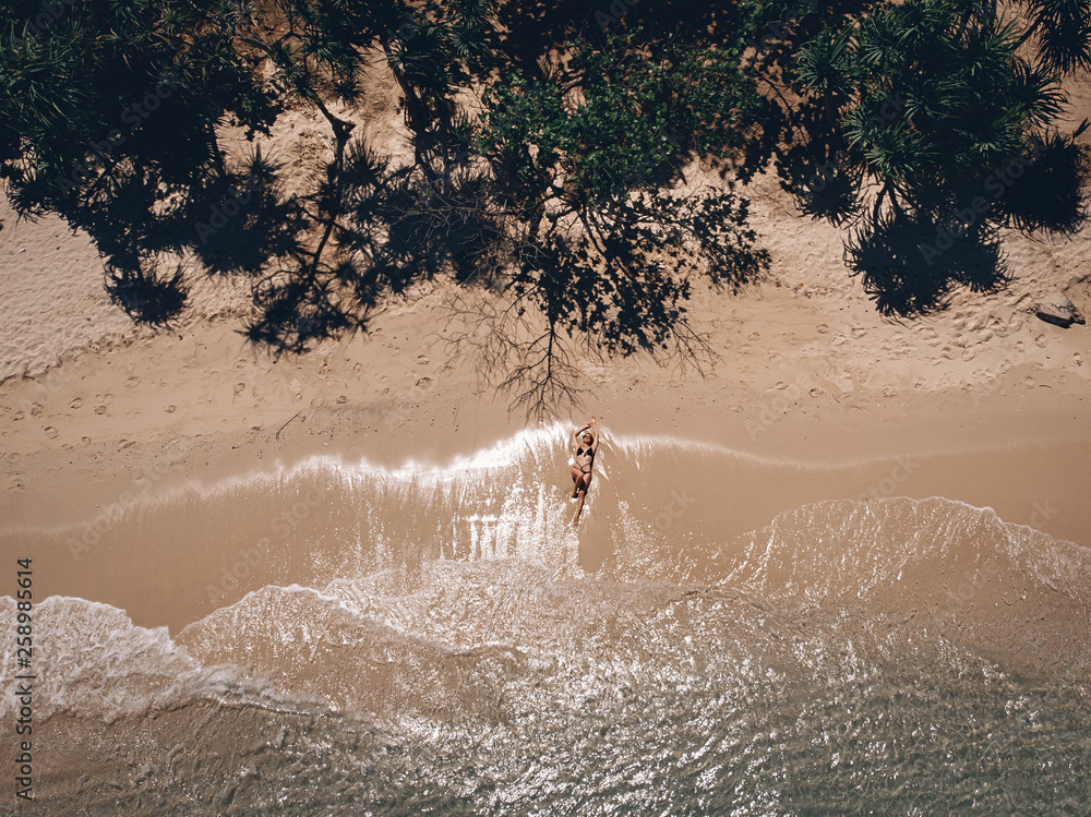 Aerial view of lying woman on the beach . Young woman on the sea ...