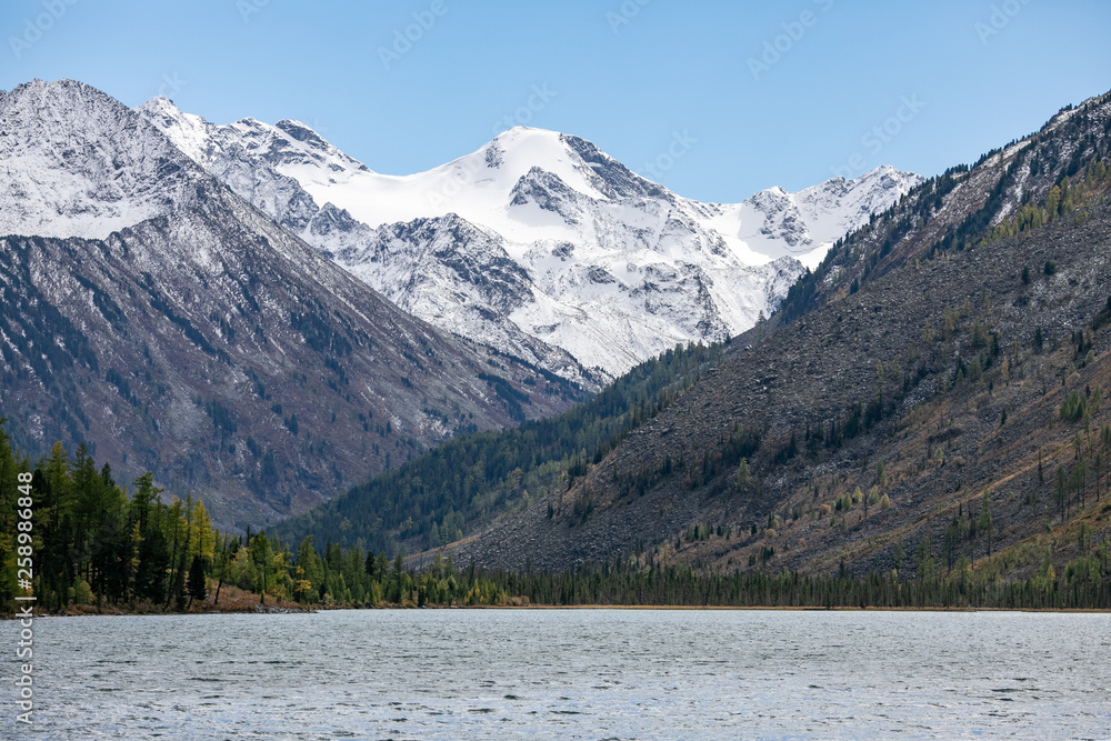 landscape with mountains, green trees and blue lake on a cloudy sky background Altai landscape with mountains, green trees and blue lake on a cloudy sky background Altai