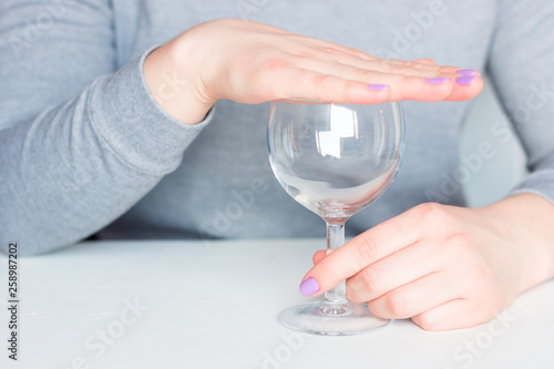 young woman covers her glass refusal alcohol photo