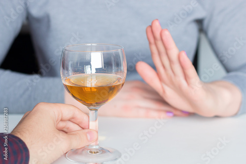 man offer alcohol but woman refuses photo