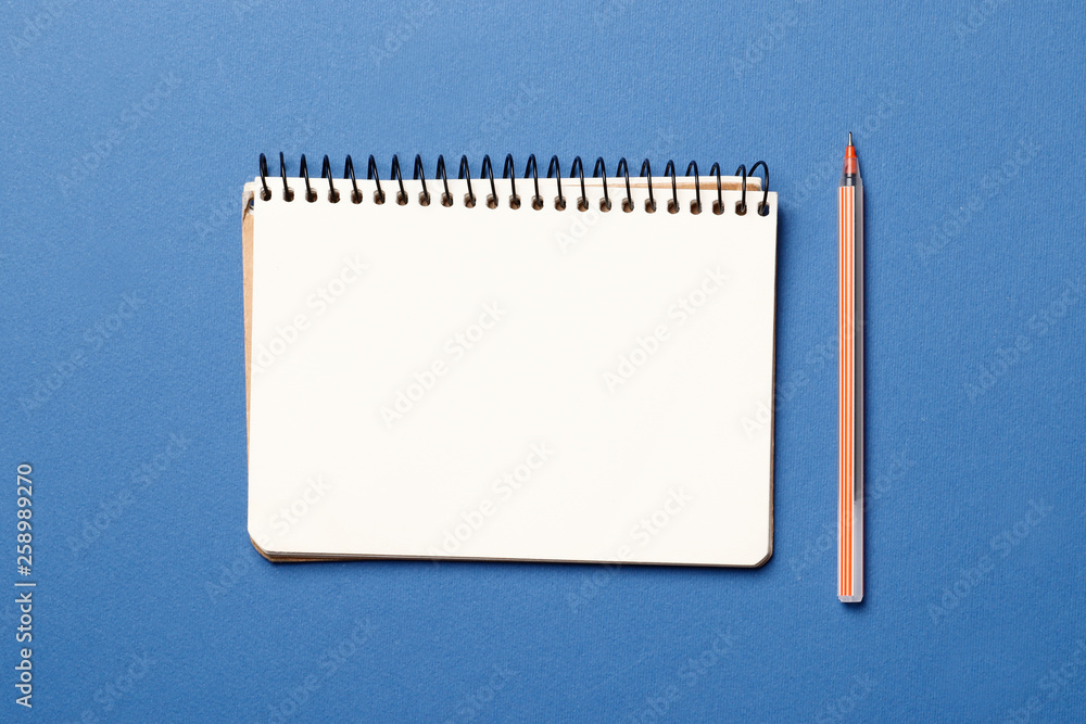 blank paper notebook with pen on blue background blank paper notebook with pen on blue background