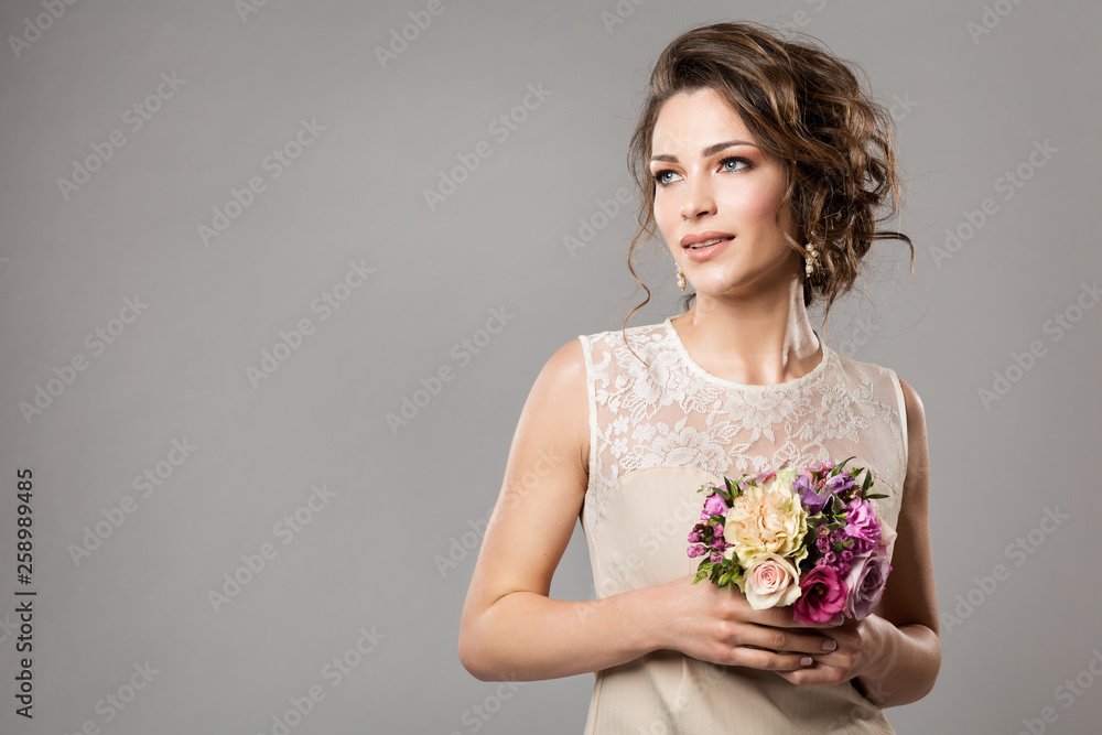 Fashion Models Beauty Portrait with Flowers Bouquet, Beautiful Woman Bridal Makeup and Hairstyle, Girl studio shot on gray background Fashion Models Beauty Portrait with Flowers Bouquet, Beautiful Woman Bridal Makeup and Hairstyle, Girl studio shot on gray background