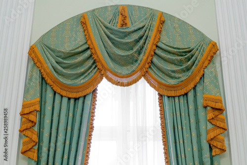 Classic beige curtain hanging on a window