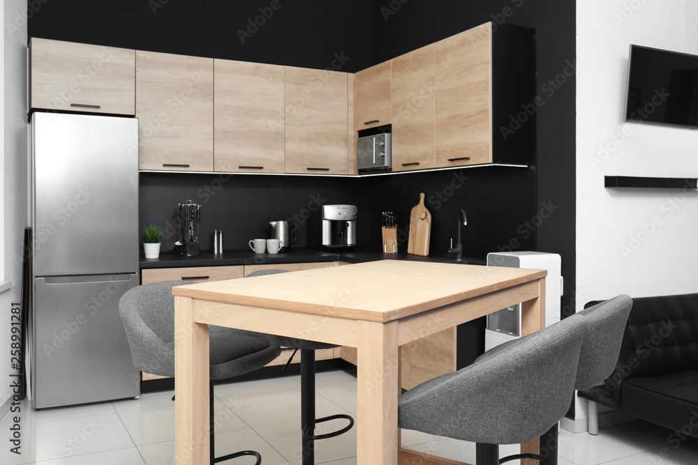 Cozy modern kitchen interior with new furniture and appliances