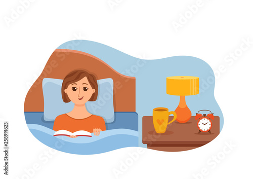 Girl lying on bed in home bedroom and reading a book © Olga