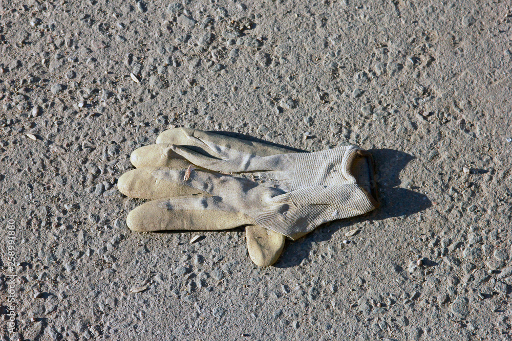 dirty used crumpled work glove lying on the ground dirty used crumpled work glove lying on the ground