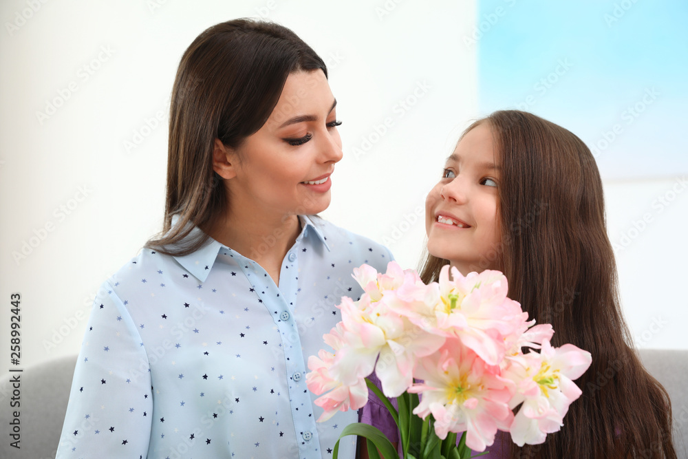 Little daughter congratulating her mom at home. Happy Mother's Day Little daughter congratulating her mom at home. Happy Mother's Day
