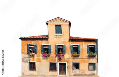 typical ancient medieval venetian house with orange plaster walls and wooden shutters isolated facade on white background