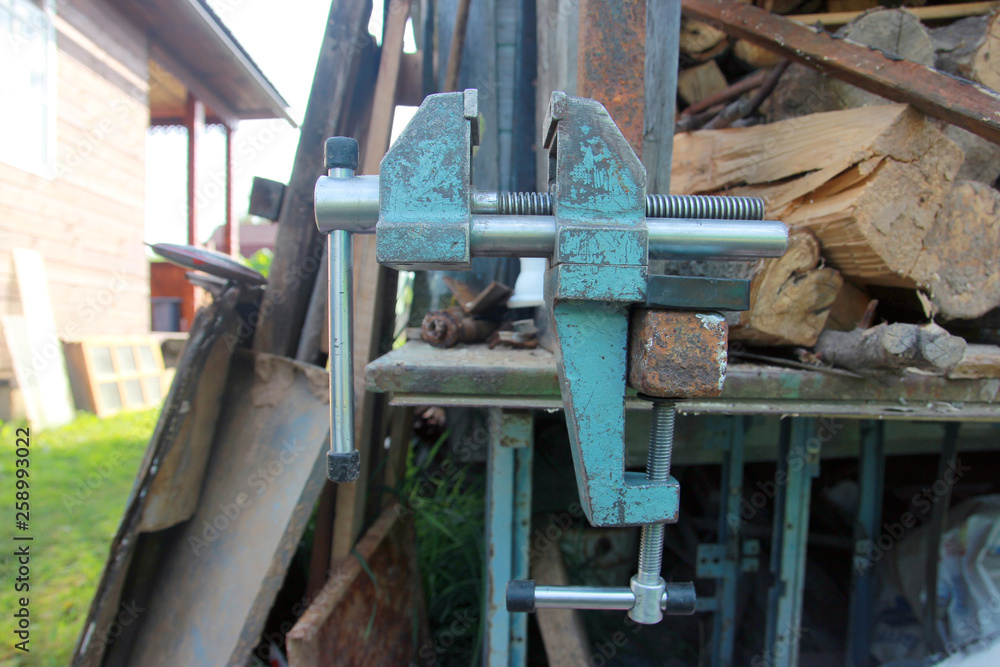iron metal heavy locksmith steel vise on the workbench in the open state closeup side view iron metal heavy locksmith steel vise on the workbench in the open state closeup side view