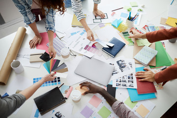 Above view closeup of creative business team brainstorming design ideas over table, copy space